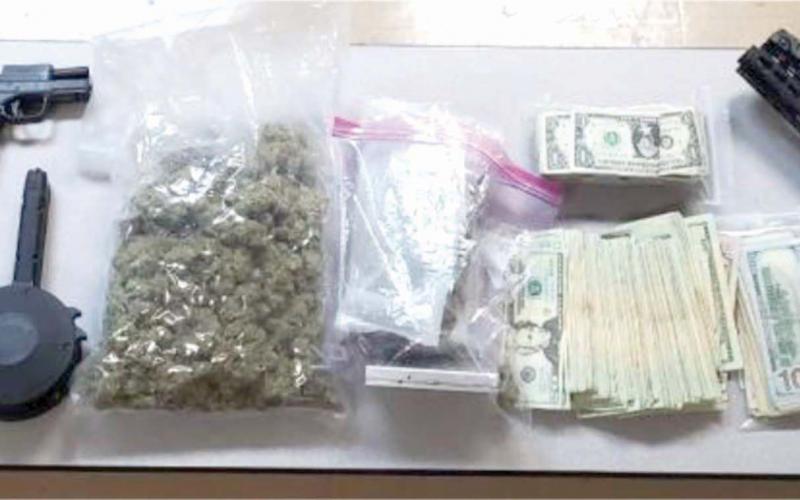 Four firearms, $10,000 in cash and 1.5 pounds of marijuana were found during a drug bust Thursday night sparked by a single-vehicle wreck. (COURTESY)