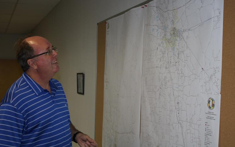 Shayne Morgan, Columbia County Emergency Management director, looks at a county map Monday afternoon in the county Emergency Operations Center as he begins to prepare for the possibility of Tropical Storm Eta impacting Columbia County. (TONY BRITT/Lake City Reporter)
