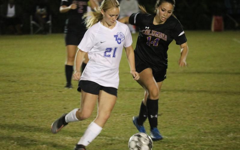 Columbia midfielder Taiya Driggers chases down possession from Taylor County’s  Rebecca Shoaff on Monday night. (JORDAN KROEGER/Lake City Reporter)
