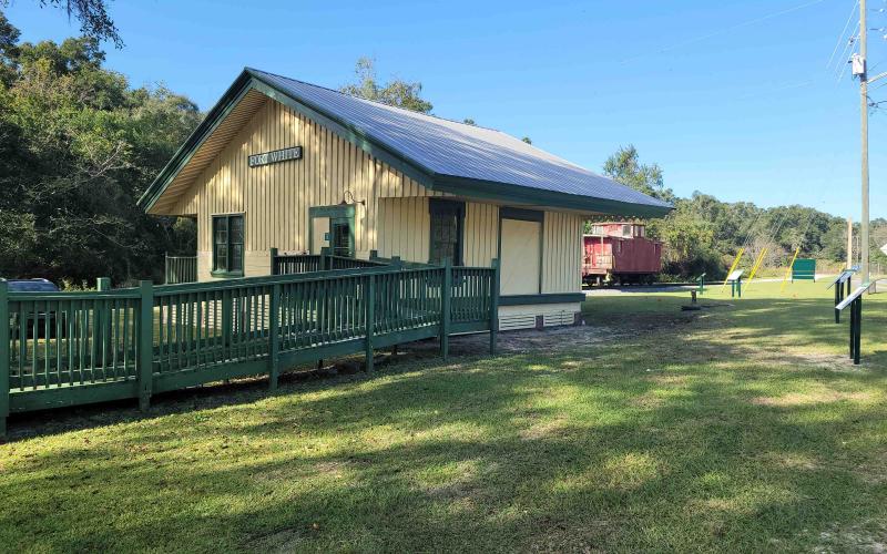 Historic Mayor’s Park in Fort White includes an old train depot and red caboose. Exhibit signs were recently installed at the park to help detail the history of the town. (COURTESY)