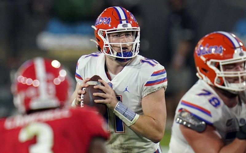 Florida quarterback Kyle Trask (11) looks for a receiver against Georgia on Saturday in Jacksonville. (JOHN RAOUX/Associated Press)