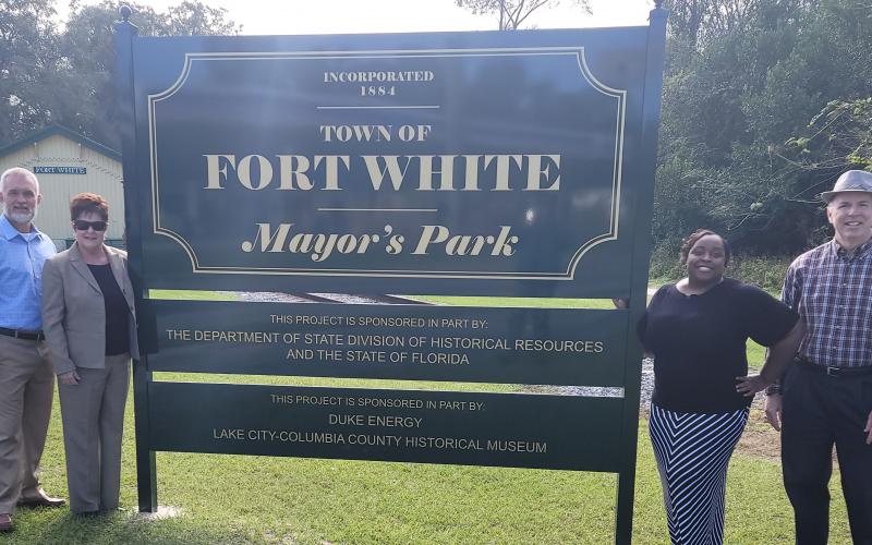 Fort White Mayor Ronnie Frazier (from left); Connie Breechen, Town Clerk; Shannon Williams, North Florida Professional Services Grant Consultant; and Sean McMahon, Lake City-Columbia County Historical Museum President; stand next to the new welcome sign erected in Mayor’s Park. (COURTESY)