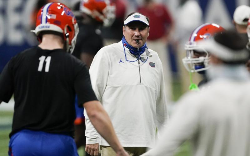 Florida head coach Dan Mullen speaks with players before the first half of the Southeastern Conference championship game between Florida and Alabama on Dec. 19 in Atlanta. (JOHN BAZEMORE/Associated Press)