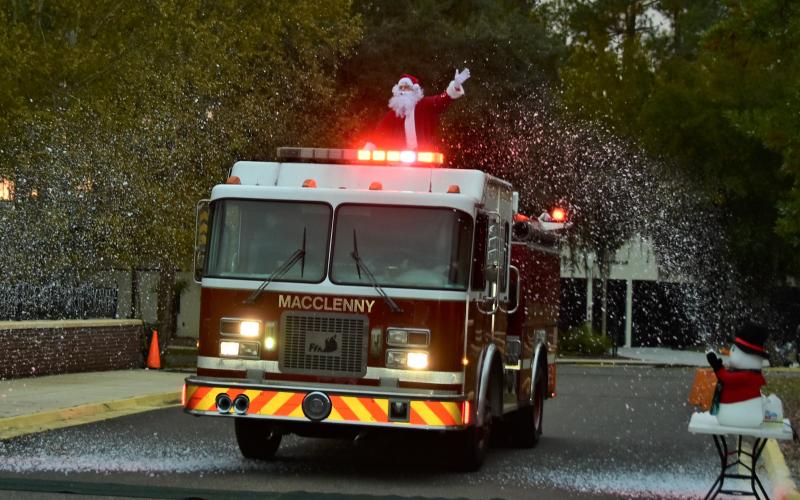 Santa Claus rides through the snow on the back of a fire truck to the Winter Wonderland at Florida Gateway College on Saturday. (ROB WOLFE/Special to the Reporter)
