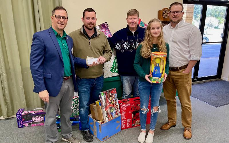 Rotary President Lee Pinchouck, Rotarian Chase Moses, Elks Toy Drive Chairman and Rotarian George Brannon, Abby Candler and Rotarian Chris Candler with monetary and toy donations given to the Elks Toy Drive. (COURTESY)