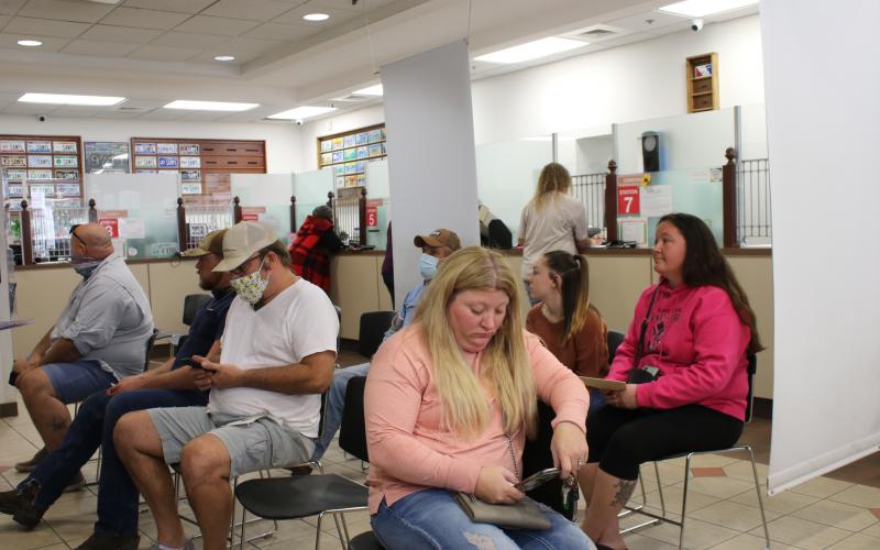 A room filled with customers await their turn at the Columbia County Tax Collectors Office on Tuesday afternoon. Activity at the office has increased as the end of the year approaches and people look to pay their taxes and other fees. The office will be closed Thursday and Friday. (TONY BRITT/Lake City Reporter)