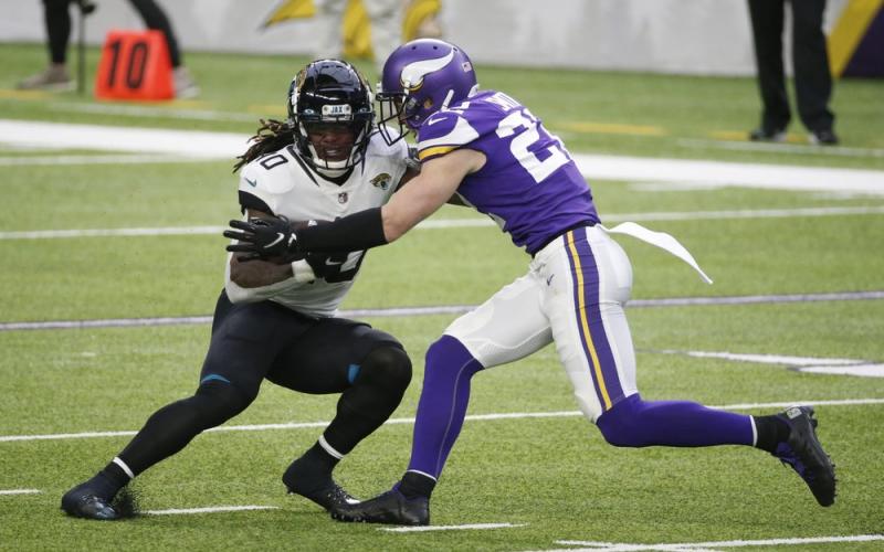 Jacksonville Jaguars wide receiver Laviska Shenault Jr. (10) tries to break a tackle by Minnesota Vikings safety Harrison Smith, right, after catching a pass on Sunday in Minneapolis. (BRUCE KLUCKHOHN/Associated Press)