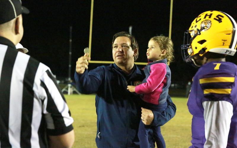 Columbia High had a special guest for Friday night’s Region 1-6A final as Gov. Ron DeSantis and his daughter Madison attended the Tigers’ game against St. Augustine at Tiger Stadium. As part of his visit, DeSantis performed the pre-game coin flip. (JEN CHASTEEN/Special to the Reporter)