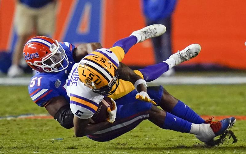 Florida linebacker Ventrell Miller (51) tackles LSU wide receiver Koy Moore after a reception on Saturday in Gainesville. (JOHN RAOUX/Associated Pressx)