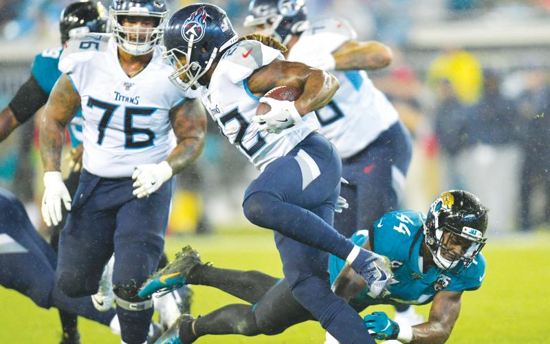 Tennessee Titans running back Derrick Henry (22) gets by Jacksonville Jaguars middle linebacker Myles Jack (44) in September of 2019 at TIAA Bank Field. (WILL DICKEY/TNS)