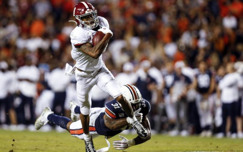 Alabama wide receiver DeVonta Smith (6) catches a pass as Auburn linebacker Chandler Wooten (31) tries to tackle him on Nov. 30 in Auburn, Ala. (AP FILE PHOTO)