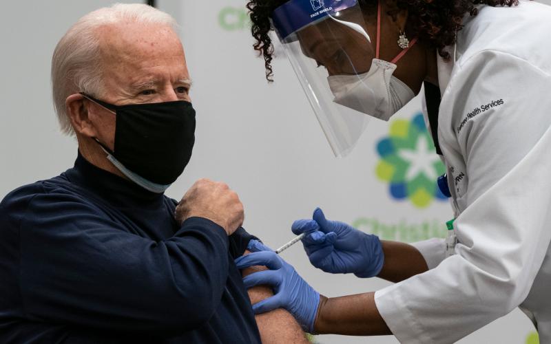 U.S. President-elect Joe Biden receives a covid-19 vaccination from Tabe Masa, nurse practitioner and head of Employee Health Services, at the Christiana Care campus in Newark, Delaware, on Monday. (ALEX EDELMAN/AFP via Getty Images/TNS)