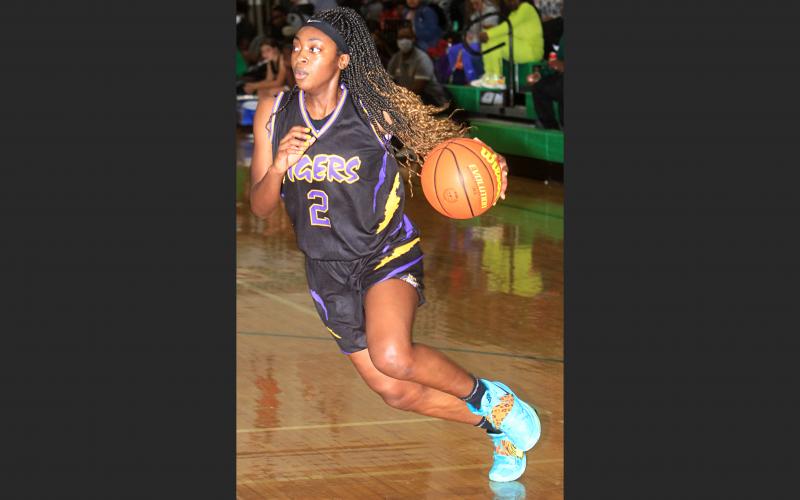 Columbia guard Na’Haviya Paxton drives to the basket against Suwannee on Saturday. (PAUL BUCHANAN/Special to the Reporter)