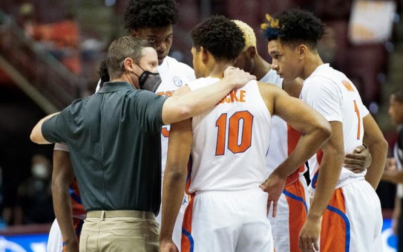 The Florida Gators huddle with coach Mike White after Keyontae Johnson collapsed during Saturday's game in Tallahassee. (MIGUEL OLIVELLA/Courtesy of ACC)