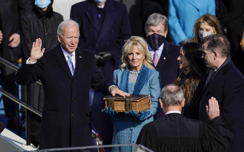 U.S. President-elect Joe Biden takes the oath of office from Supreme Court Chief Justice John Roberts as his wife U.S. First Lady-elect Jill Biden stands next to him during the 59th presidential inauguration on Wednesday in Washington, D.C. (KENT NISHIMURA/Los Angeles Times/TNS)