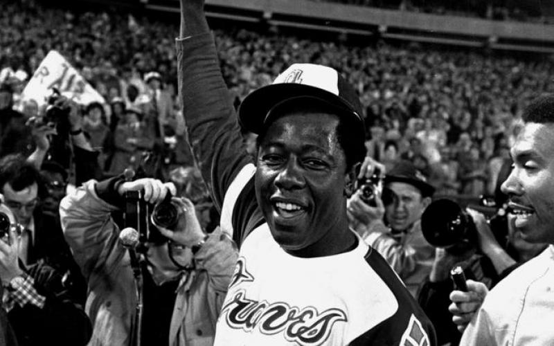 Hank Aaron celebrates after his 715th career home run in 1974. (AP FILE PHOTO)