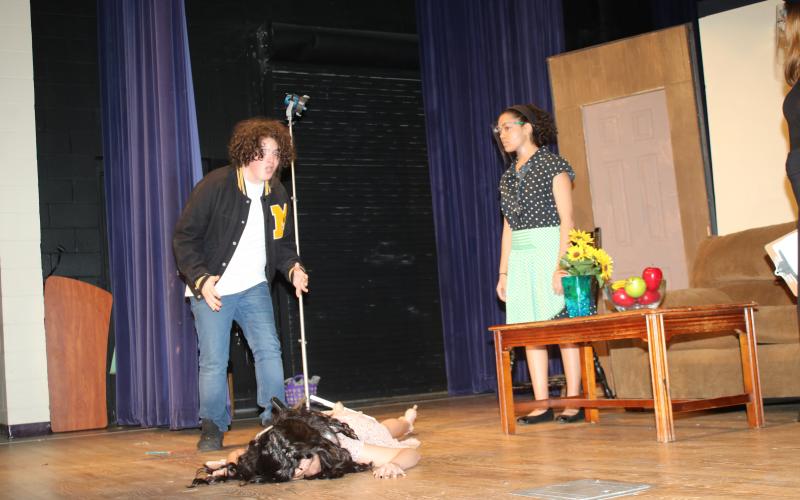 Nick Stewart reacts to Rose Brocchi playing a dead woman during dress rehearsal for the Columbia High dinner/theater production of ‘The Bold, the Young, and the Murdered.’ The CHS drama club and culinary arts program will host the play tonight and tomorrow at the Norman L. Choice Performing Arts Center. (TONY BRITT/Lake City Reporter)