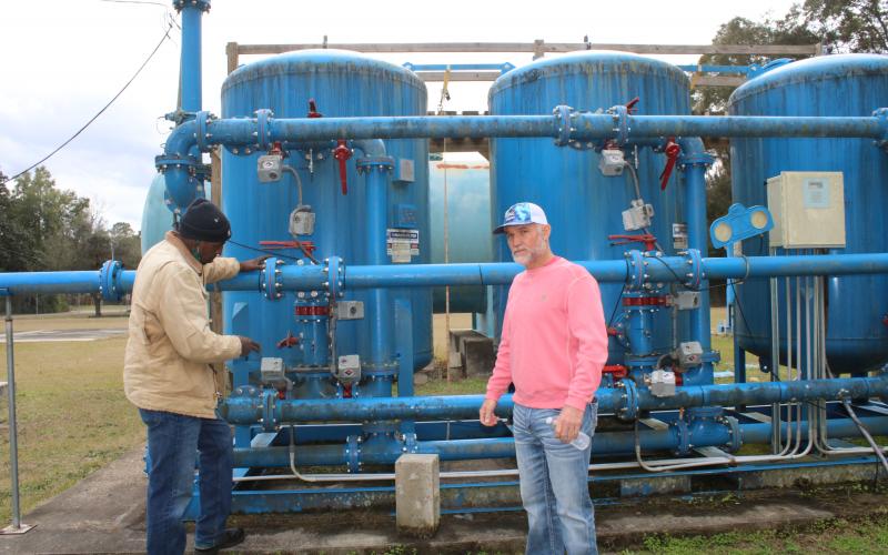 Vernon Zinnerman (from left), Fort White public works director shows Ronnie Frazier, Fort White mayor, the town’s water plant’s charcoal filter system, as they visually inspect the plant Friday afternoon. (TONY BRITT/Lake City Reporter)