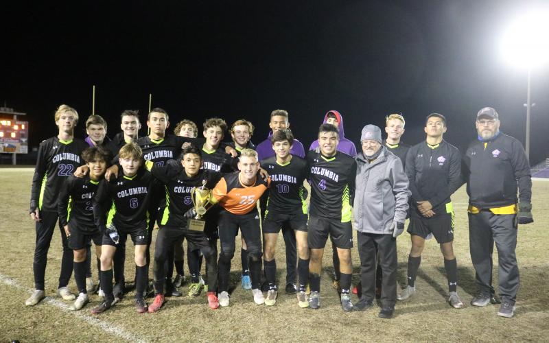 Columbia’s soccer team poses with the Three Rivers Cup after defeating Santa Fe 2-1 at home on Friday. (TONY BRITT/Lake City Reporter)
