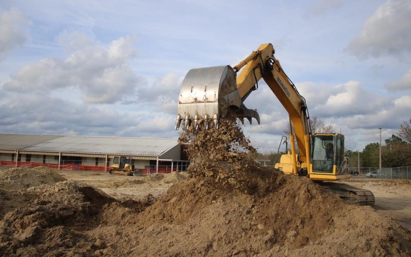 Ken Wells, of Bubba’s Site Prep, uses an excavator to move dirt while prepping a site for the Westside Elementary School multi-purpose room. Construction on the project began last week and is expected to be completed by the end of summer. (TONY BRITT/Lake City Reporter)