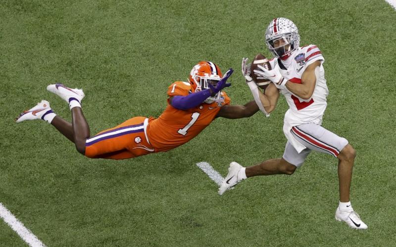 Ohio State wide receiver Chris Olave catches a touchdown pass in front of Clemson cornerback Derion Kendrick during the second half of the Sugar Bowl on Friday in New Orleans. (BUTCH DILL/Associated Press)