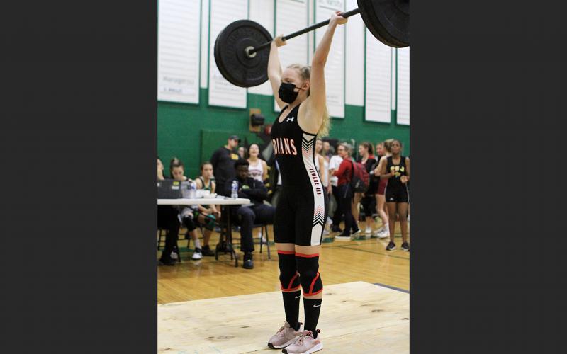 Fort White’s Katie Griffith finishes her clean and jerk at the Region 1-1A meet. Griffith won first place in the 101 class. (PAUL BUCHNAN/Special to the Reporter)
