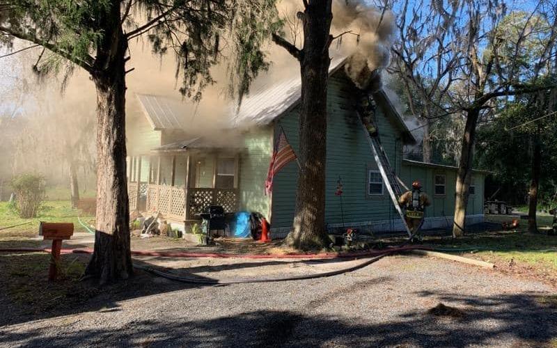 Firefighters with the Live Oak Fire Department battle a house fire on Lisle Ave. NE on Monday morning. The house sustained ‘considerable damage.’ (COURTESY SUWANNEE COUNTY FIRE RESCUE)
