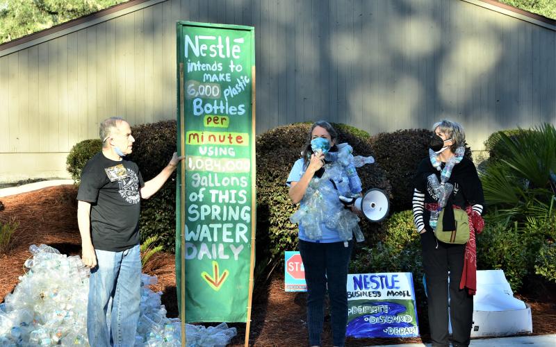Our Santa Fe River members Michael Roth, from left, Merrillee Malwitz-Jipson and Kristin Rubin protest outside the Suwannee River Water Management District headquarters Tuesday morning. (ROB WOLFE/Special to the Reporter)