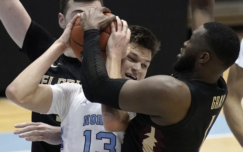 Florida State forward RaiQuan Gray (1) and North Carolina forward Walker Kessler (13) struggle for the ball during Saturday's game in Chapel Hill, N.C. (GERRY BROOME/Associated Press)