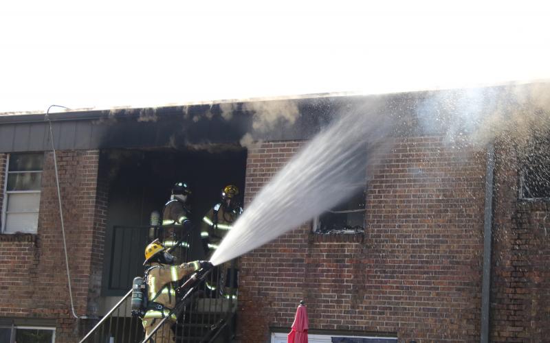 Firefighters battle a structure fire that destroyed four apartments in the Columbia Arms Apartment Complex Saturday. The cause of the fire remains under investigation. (TONY BRITT/Lake City Reporter)