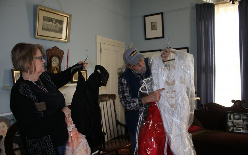 Kim Estergren, Lake City-Columbia County Historical Museum president-elect, and Harry Joiner, past president, work on moving dresses for the museum’s dress sale fundraiser today and Saturday. The sale will last from 9 a.m. to 1 p.m. both days at the museum, 157 SE Hernando Avenue. (TONY BRITT/Lake City Reporter)