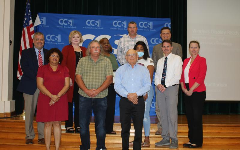 Columbia County school district staffers were honored after they saved maintenance department worker Jim Osburn last year after he fell off a ladder. The brief recognition ceremony took place Tuesday night during the school board meeting. Narrie Smith (front row, from left) Osburn and Keith Hudson. (Back row, from left) Lex Carswell, Stephanie Johns, Phyllisteen Reese, Casey Starling, Sandra Bing, Steve Nelson, Robert Cooper and Dana Brady-Giddens. (TONY BRITT/Lake City Reporter)