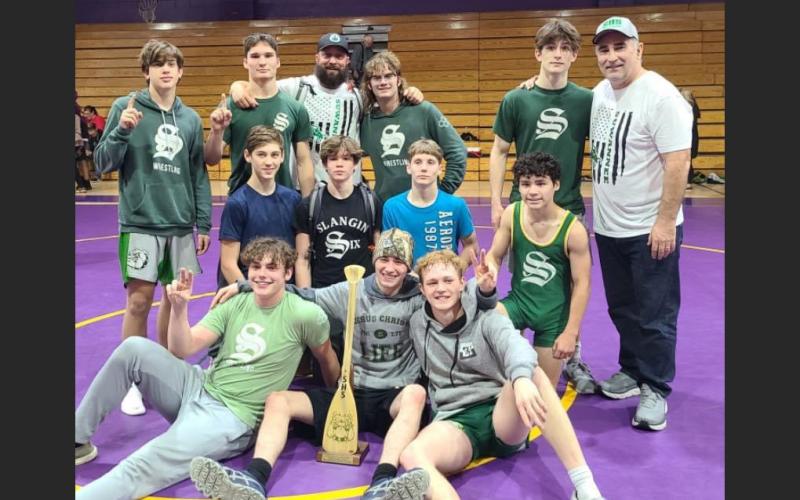 Suwannee's wrestling team poses in celebration after defeating Columbia on Wednesday. (COURTESY)