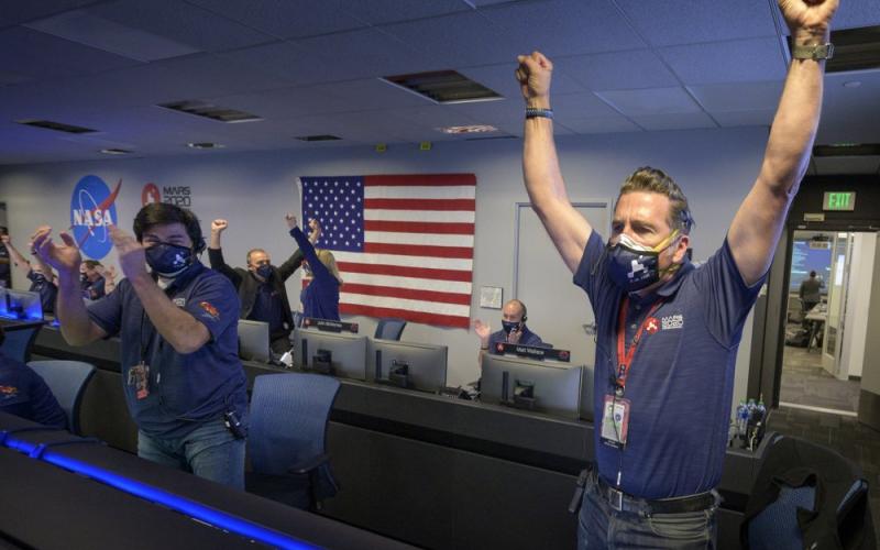 In this photo provided by NASA, members of NASA's Perseverance rover team react in mission control after receiving confirmation the spacecraft successfully touched down on Mars at NASA's Jet Propulsion Laboratory on Thursday in Pasadena, Calif. The landing of the six-wheeled vehicle marks the third visit to Mars in just over a week. Two spacecraft from the United Arab Emirates and China swung into orbit around the planet on successive days last week. (COURTESY OF NASA)
