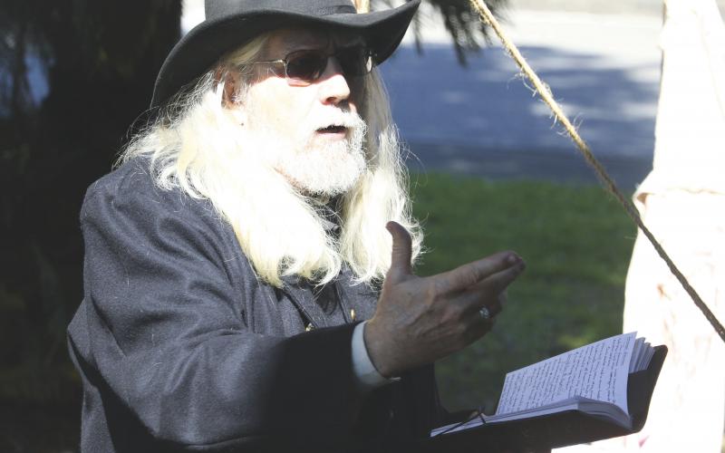 Lake City-Columbia County Historical Museum volunteer Harry Joiner reads an excerpt from the diary of a Civil War doctor on treating wounded men on Saturday. (MORGAN MCMULLEN/Lake City Reporter)