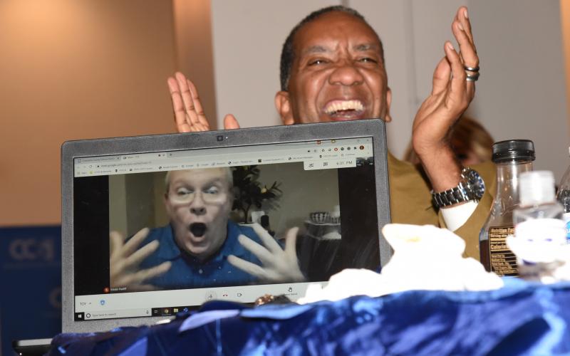 Burney Ratliff, reacts to being named the 2022 Columbia County Teacher of the Year, during his Zoom computer connection as Glenn Palmer, Pathways Academy assistant principal, smiles and cheers in the background. (COURTESY)
