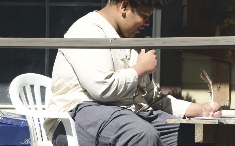 Jayden Burch, a 17-year-old at Columbia High School, performs a monologue as former slave Jordan Anderson writing a letter to his former master. (MORGAN MCMULLEN/Lake City Reporter)