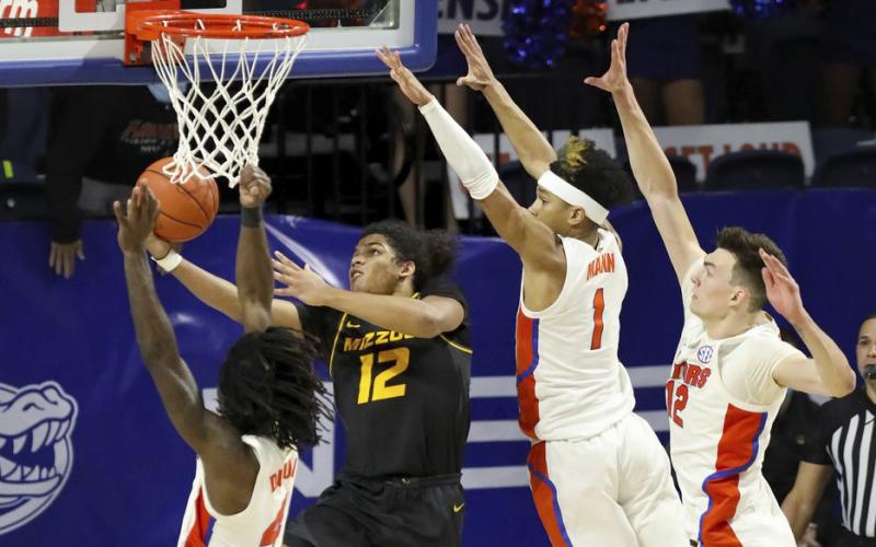 Missouri guard Dru Smith (12) goes up and under the basket to score the game-winning basket against Florida on Wednesday in Gainesville. (BRAD MCCLENNY McClenny/The Gainesville Sun via AP)