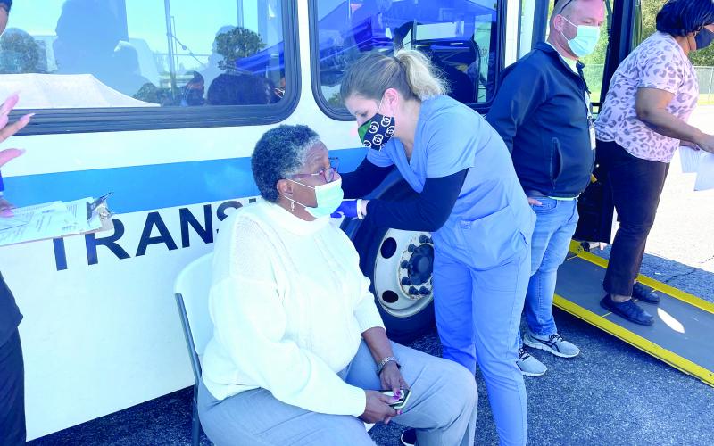 Blondell Johnson receives a vaccination shot Thursday after receiving a ride from the Richardson Community Center to the vaccination site. (COURTESY)