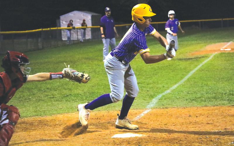 Columbia second baseman Truitt Todd lays down a bunt to score Cole Williams for the  game-winning win against Baker County on Tuesday night. (MORGAN MCMULLEN/Lake City Reporter)