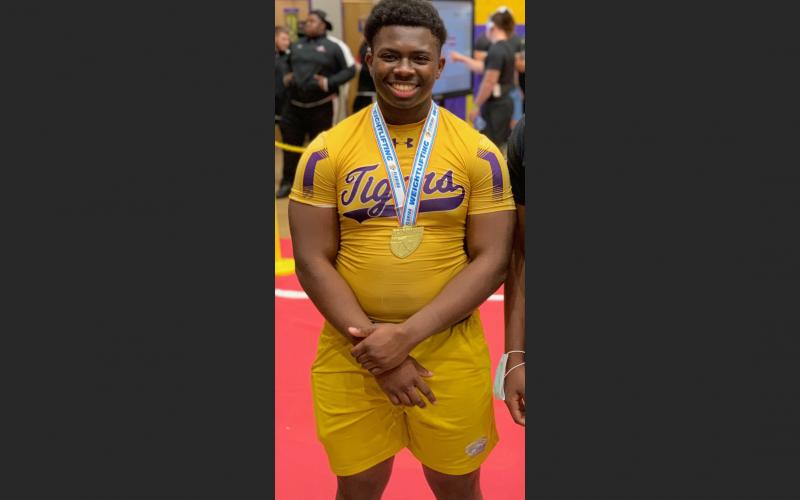 Columbia’s Julius Moreland smiles with his state medal after winning the Class 2A state title in the 219-pound weight class on Saturday. (COURTESY)
