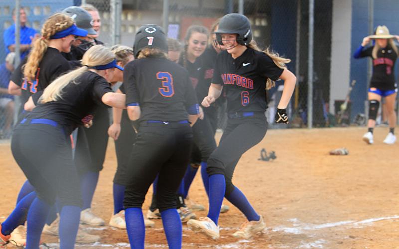 Branford third baseman Madyson Sikes strolls into home plate and celebrates with her teammates after hitting one of her two home runs against Hilliard during Thursday’s Region 3-1A semifinal. (PAUL BUCHANAN/Special to the Reporter)