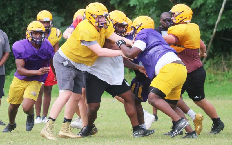 Columbia’s offensive line battles the defensive line during practice last Thursday. Caleb Pope and Travis Matthews are getting their first varsity looks at tackle this spring. (JORDAN KROEGER/Lake City Reporter)