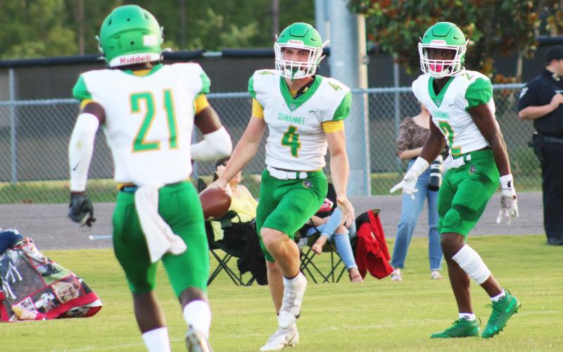 Suwannee receiver Garrison Beach (4) celebrates with teammates after catching a touchdown pass against Oakleaf in the teams’ spring game on May 21. (JAMIE WACHTER/Lake City Reporter)