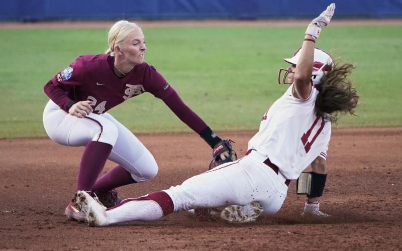 Florida State third baseman Sydney Sherrill tags out Oklahoma's Nicole Mendes (11) during the second inning in Game 1 of the Women's College World Series championship series on Tuesday in Oklahoma City. (SUE OGROCKI/Associated Press)