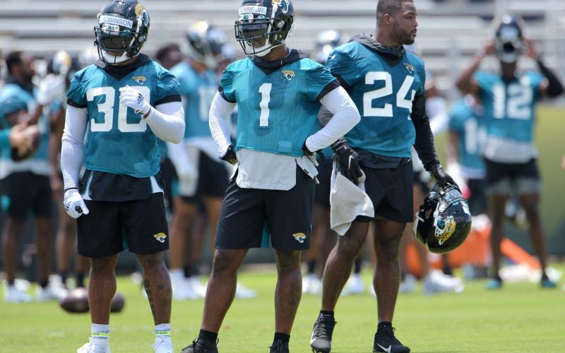Jacksonville Jaguars running backs James Robinson (30), Travis Etienne (1) and Carlos Hyde (24) on the field during drills at an OTA session on May 27. (BOB SELF/Florida Times-Union/TNS)