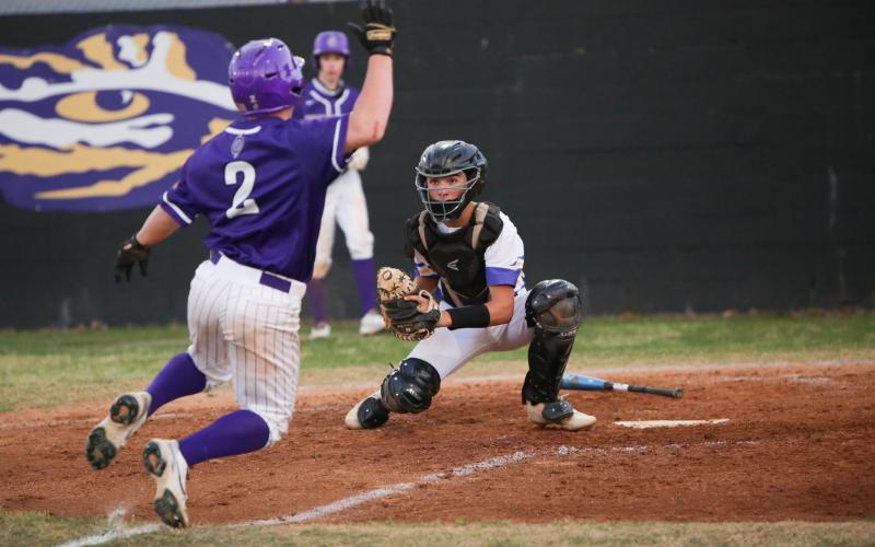 Columbia catcher Grant Bowers gathers a throw at home plate for a tag against Gainesville last season. (BRENT KUYKENDALL/Lake City Reporter)