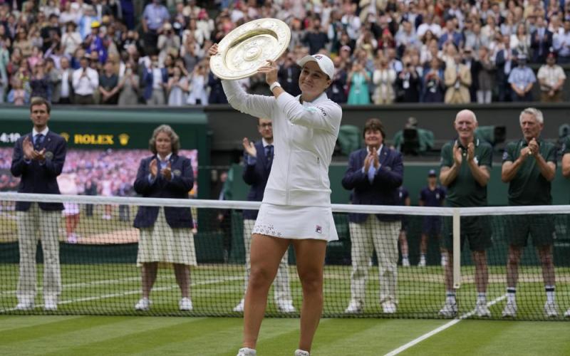 Ashleigh Barty poses with the trophy for the media after defeating Karolina Pliskova to win the Wimbledon women's singles final on Saturday in London. (KIRSTY WIGGLESWORTH/Associated Press)