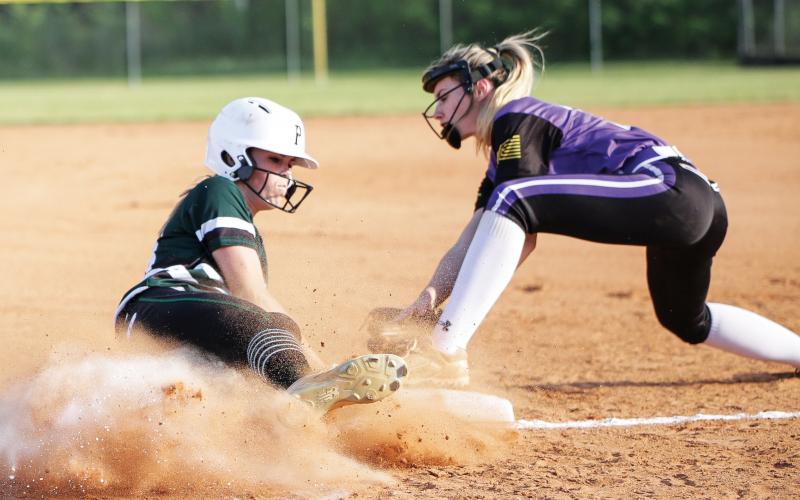 Suwannee’s Karis Smith (left) slides in underneath a tag last season against Columbia. Smith ended her junior season as the team’s ace in the cirlce, finishing 8-4 with a 2.88 ERA. (BRENT KUYKENDALL/Lake City Reporter)
