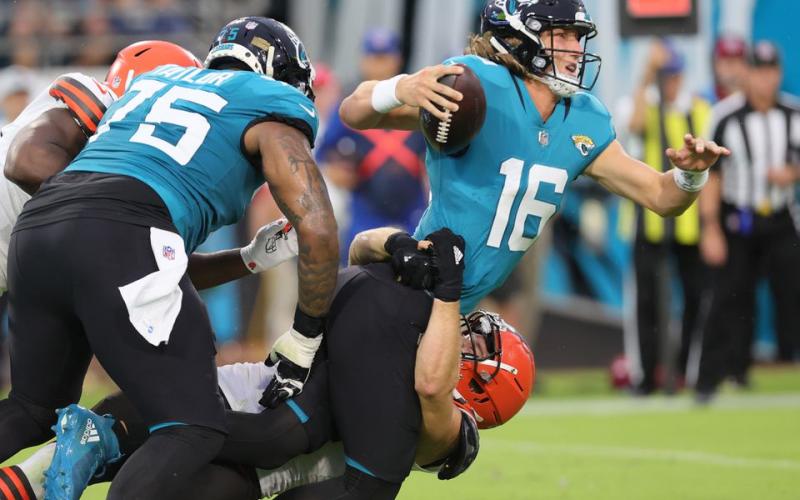 Cleveland Browns defensive end Porter Gustin (bottom) is able to get by the block of Jacksonville Jaguars offensive tackle Jawaan Taylor (L) to get a sack on Jaguars quarterback Trevor Lawrence at TIAA Bank Field on Saturday in Jacksonville. (JOHN KUNTZ/TNS)